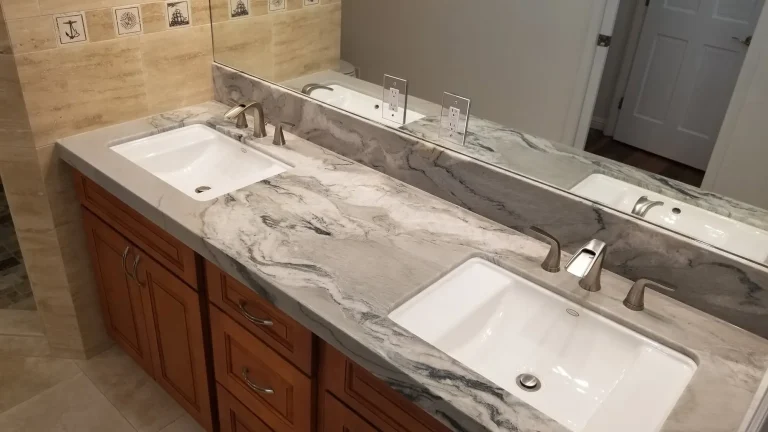Double vanity with veined stone counter, undermount sinks and wood cabinetry