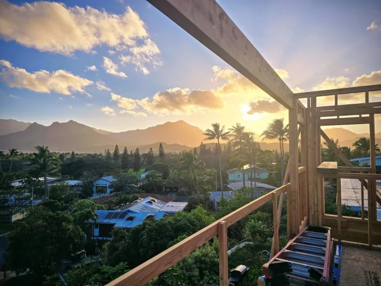 Framing at sunset with mountains and a neighborhood below