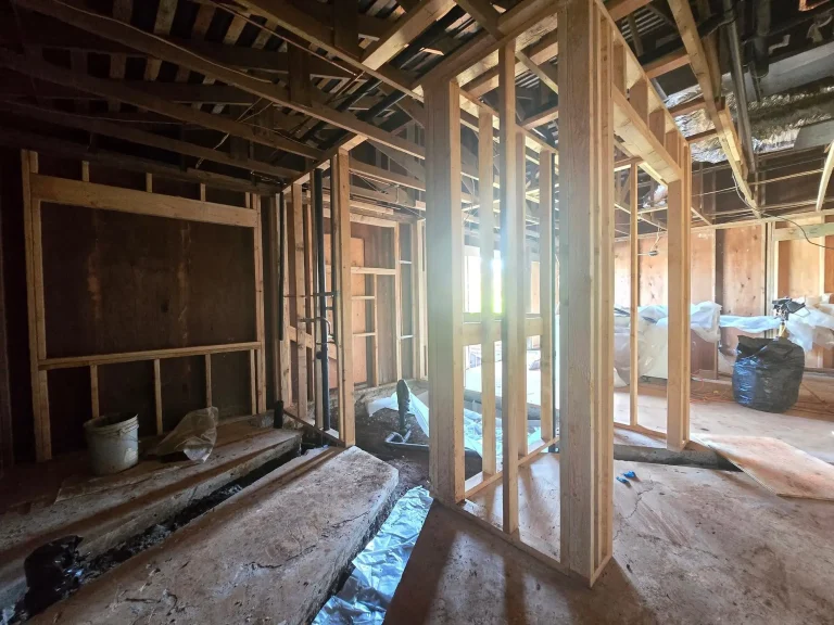 Interior opened to the framing during a renovation, showing new and existing wall structure