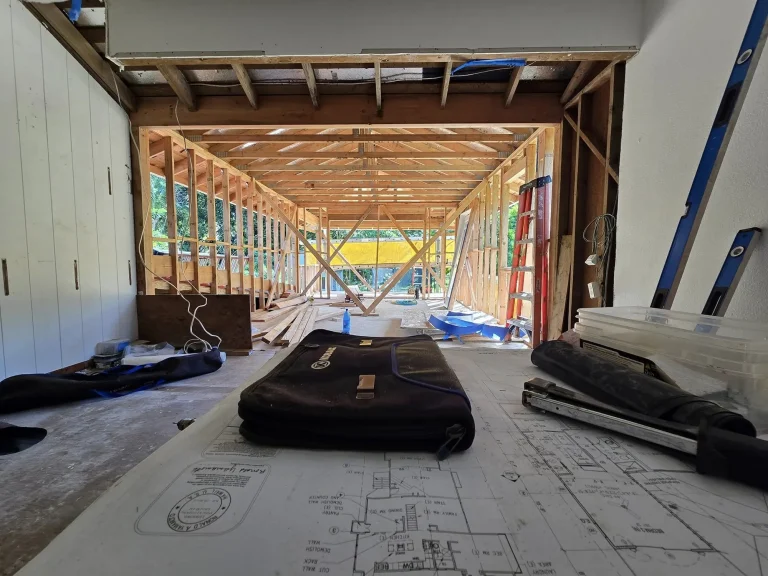 Construction plans laid out on site inside a framed space
